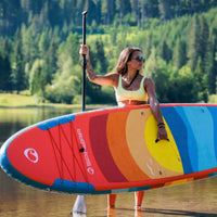 Thumbnail for Spinera Supventure Sunset 10.6 Paddle Board With a Woman Standing Holding a Paddle and a Board