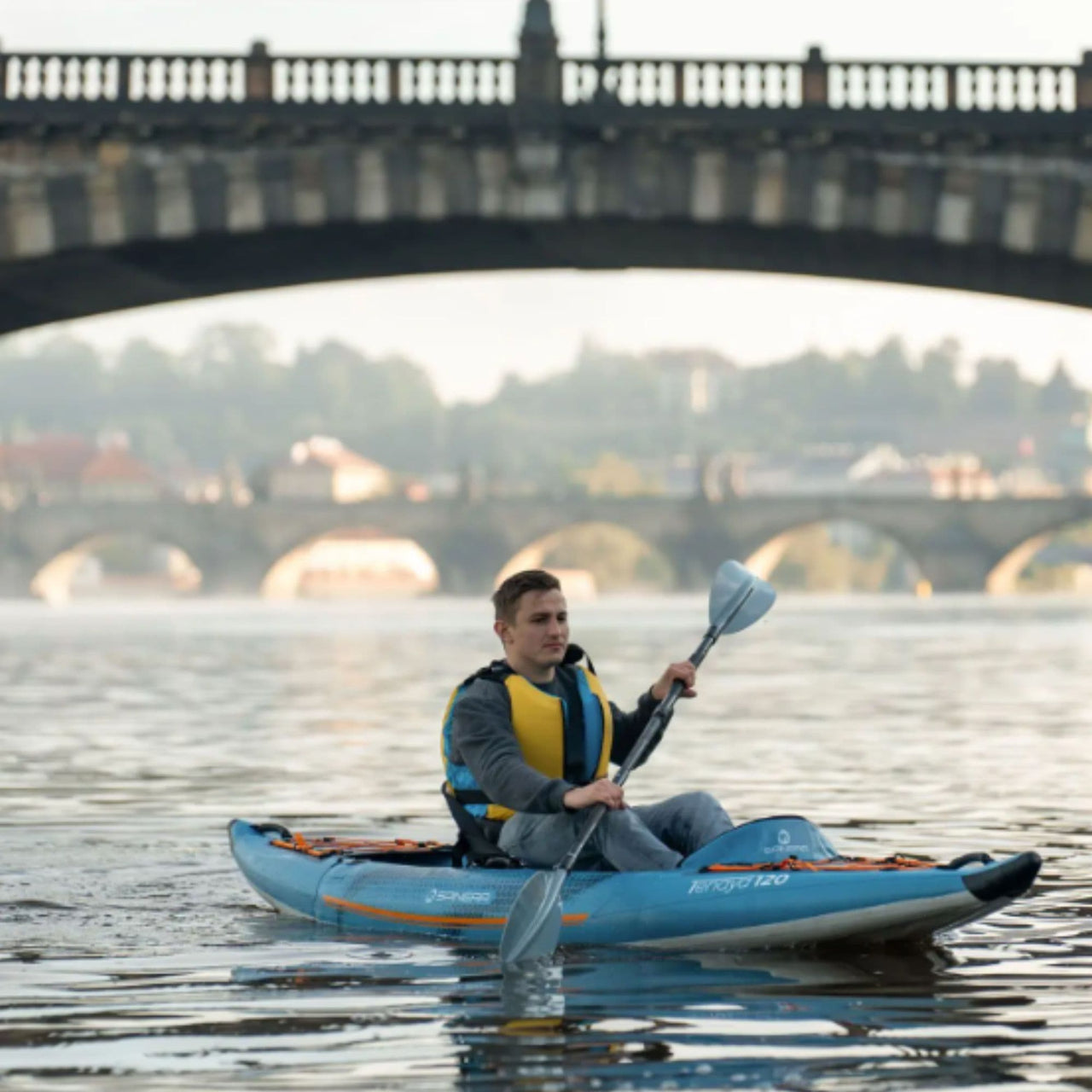 Spinera Tenaya 120 With a Man Kayaking Under Bridge On Calm Water