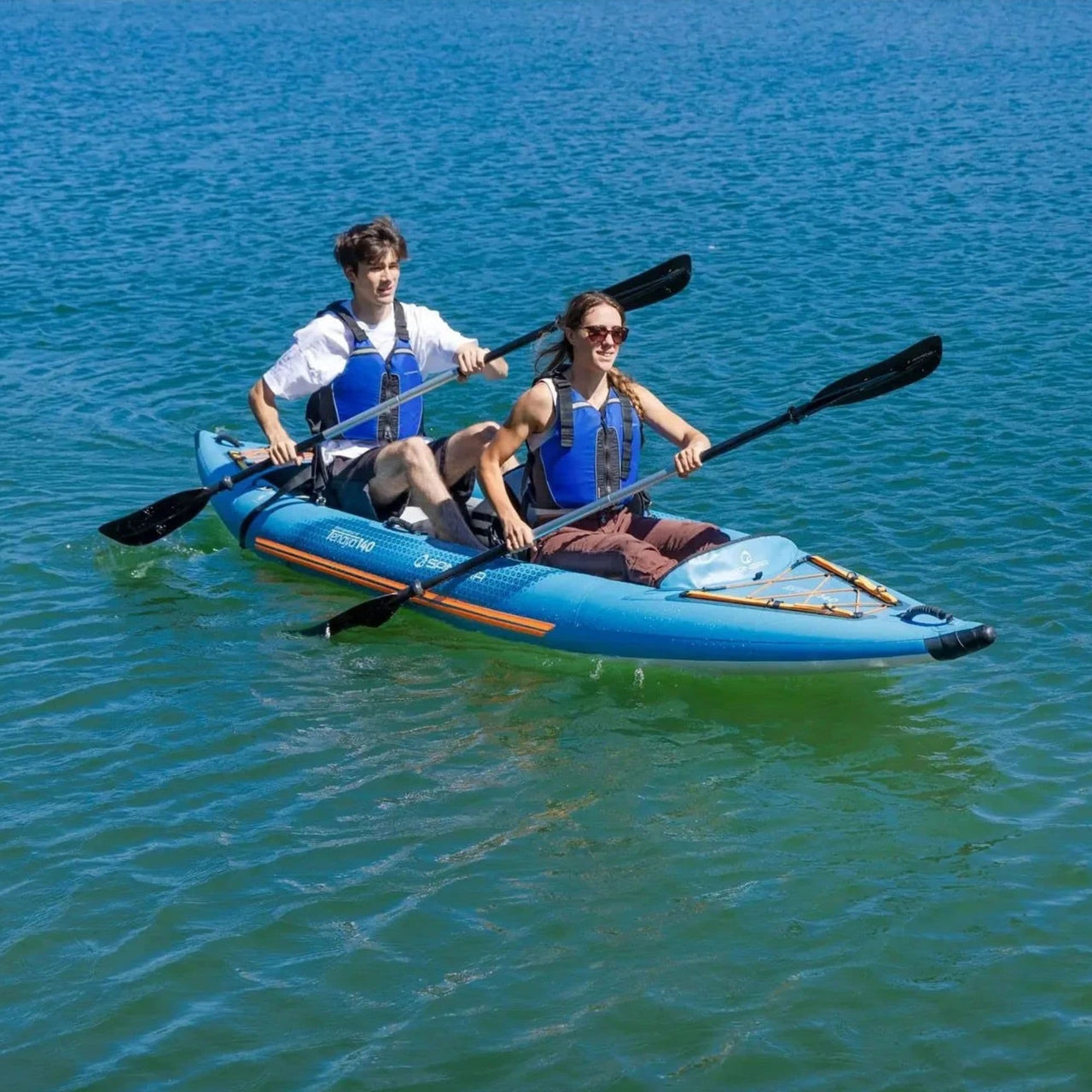 Spinera Tenaya 140 Inflatable Kayak With A Boy And Girl Kayaking And Paddling In Blue Waters