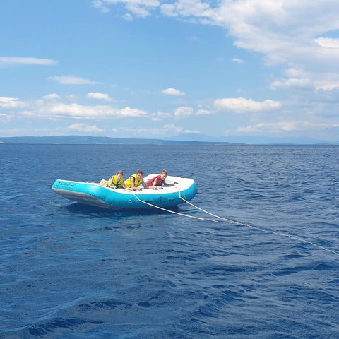 Spinera Wing 5-Person Towable With Three Boys Ready for the Ride