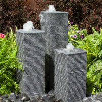 Thumbnail for Square Chiseled Stone Towers Outdoor Fountain With Colorful Plants Background