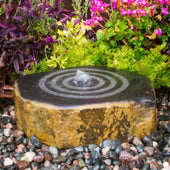 Suwaru Outdoor Fountain With Colorful Flowers In The Back