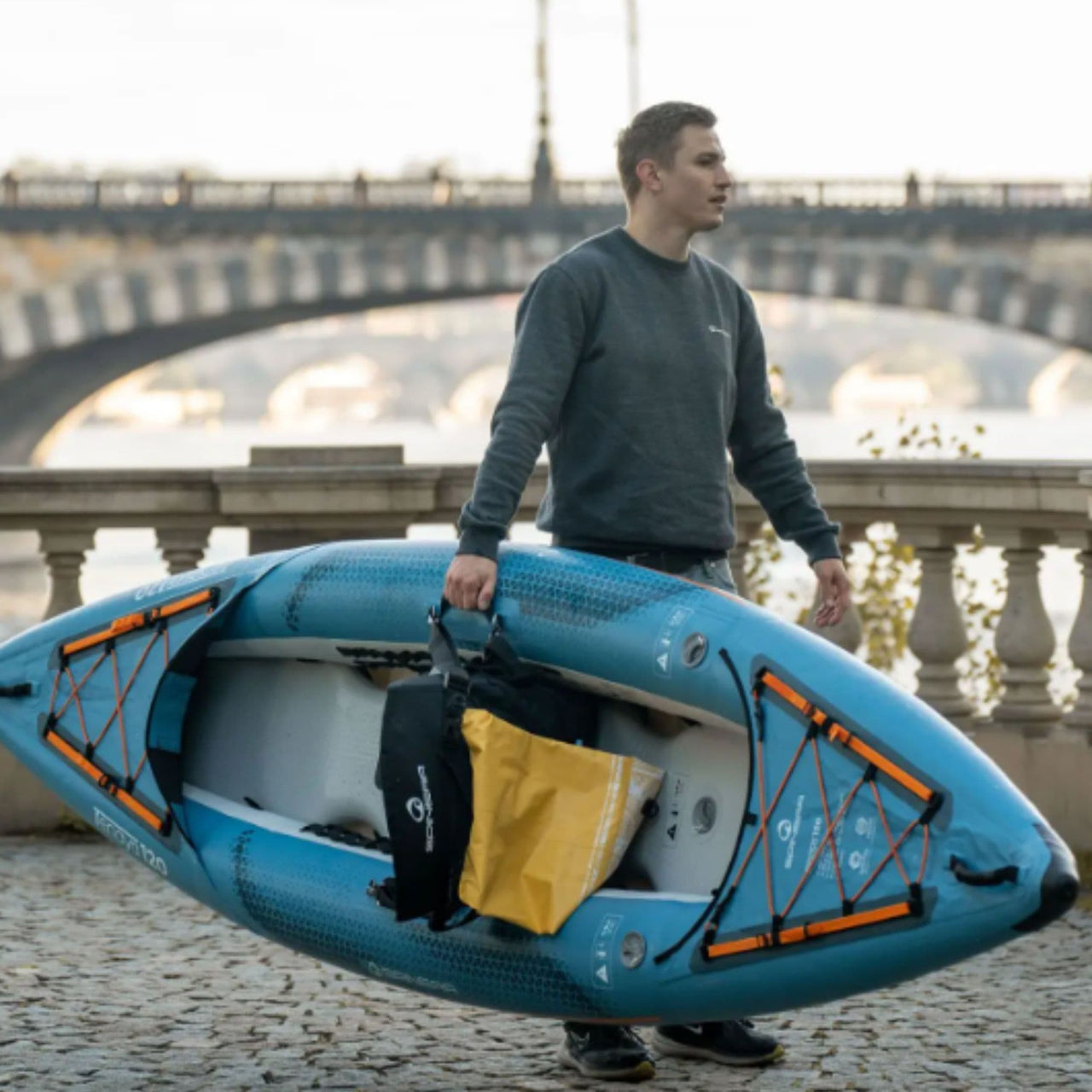 Tenaya 120 Kayak Man Carrying On his Right Hand By River
