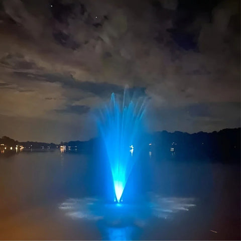 Transform Your Water Feature with Vanguard LED Color Changing Fountain Lights With Glowing Blue Lighting Beneath Cloudy Night Sky