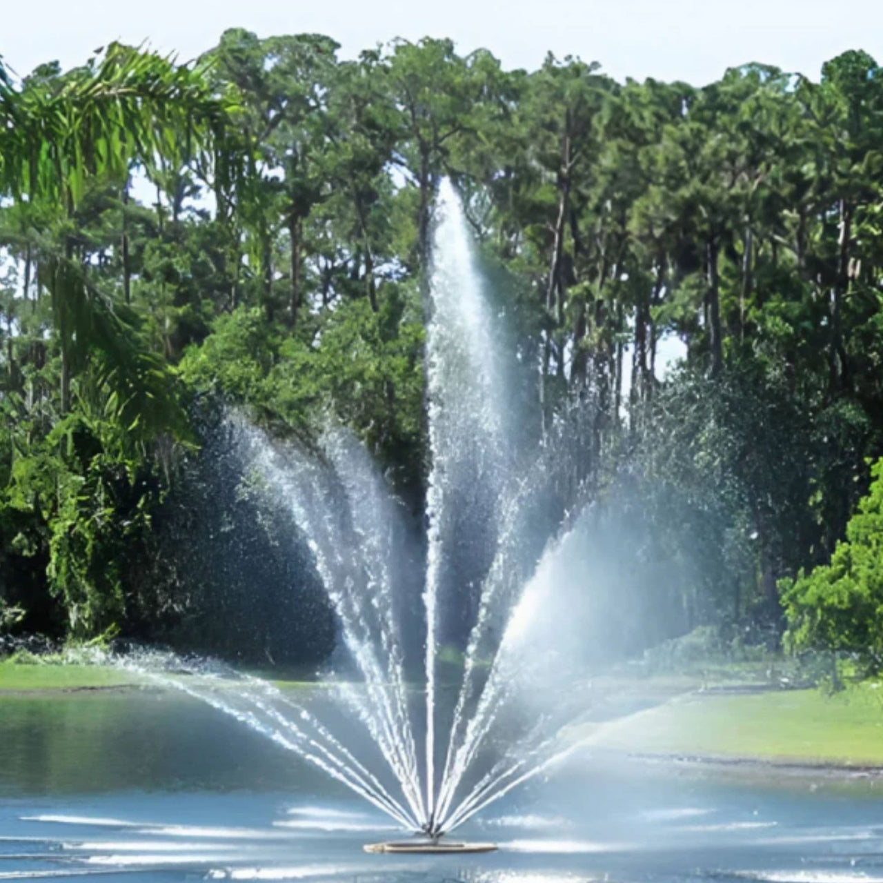 TriTier Pond Fountain Water Splashing With Trees Behind