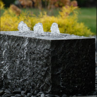 Thumbnail for Triple Drilled Yasuyuki Stone Fountain With Colorful Plants And Vibrant Foliage Background