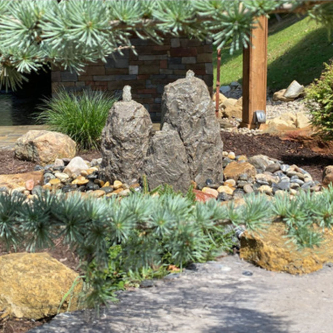 Triple Matterhorn Outdoor Fountain Rock Surrounded By Green Plants