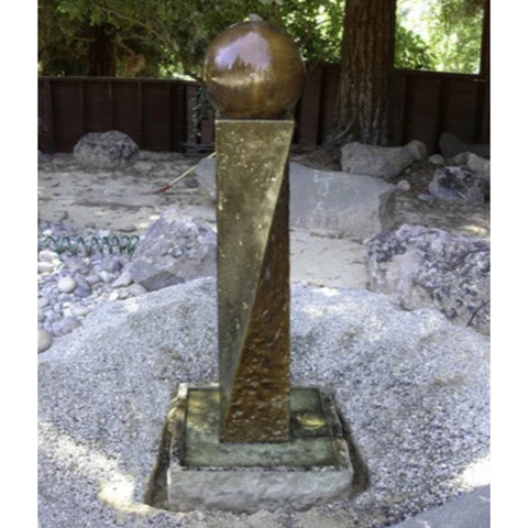 Twist Rock Fountain With Ball Finial And Rock Texture On A Rock Garden And Gravel Bed With Wooden Bench In The Background