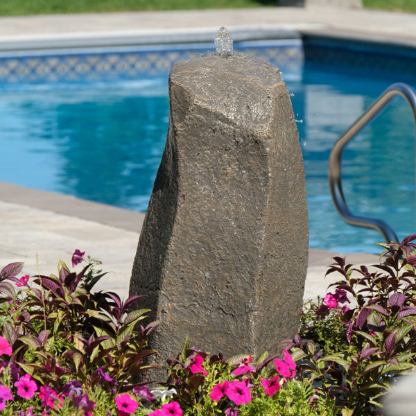 Twisted Creek Garden Fountain Rock Surrounded By Flowers And A Pool In The Background