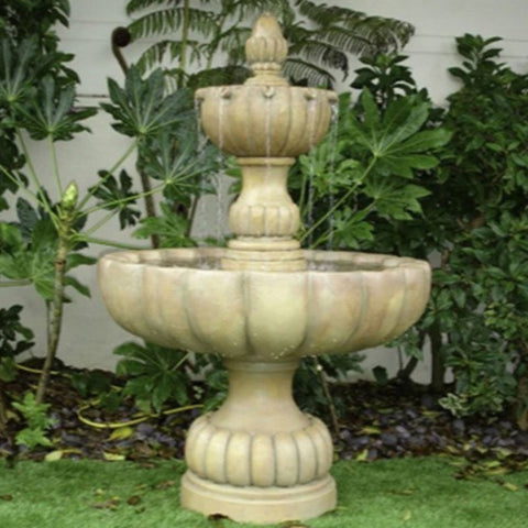 Urbino Grande Short Two Tier Fountain With Greenery In The Background