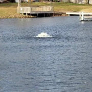 Vanguard Pond Spa Surface Aerator/De-Icer On The Water With A Dock Behind It