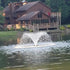Thumbnail for Vanguard Typhoon 3/4 HP Floating Display Aerator On The Water With A Cabin House In The Background