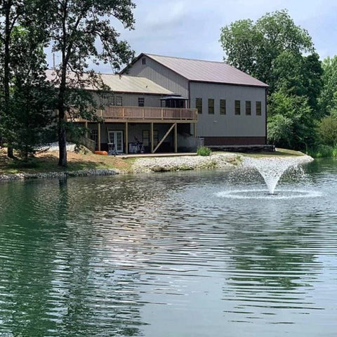 Vanguard Typhoon 3/4 HP Floating Display Aerator On The Water With A House In The Background