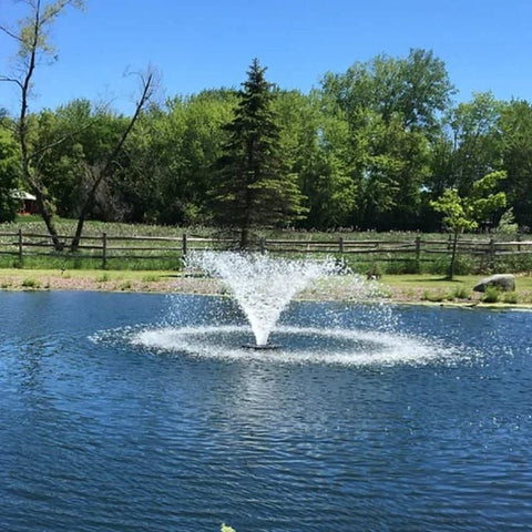 Vanguard Typhoon 3/4 HP Floating Display Aerator On Water With Green Trees In The Background