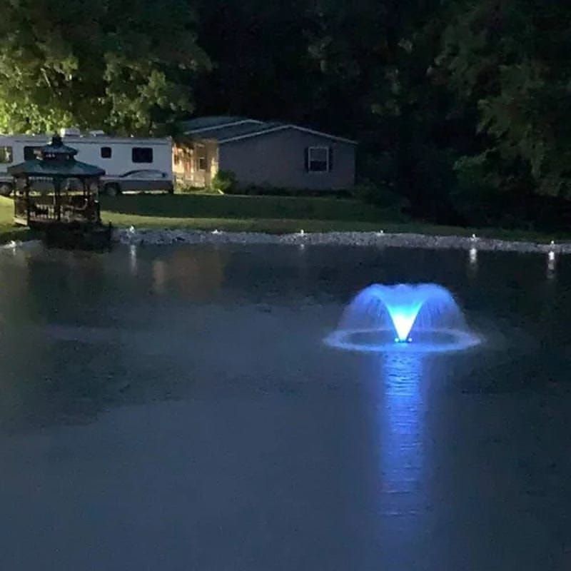 Vanguard Typhoon 3/4 HP Floating Display Aerator With Blue Lights On The Water & A House In The Background