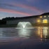 Thumbnail for Vanguard Typhoon 3/4 HP Floating Display Aerator With Lights On The Water & A Building In The Background