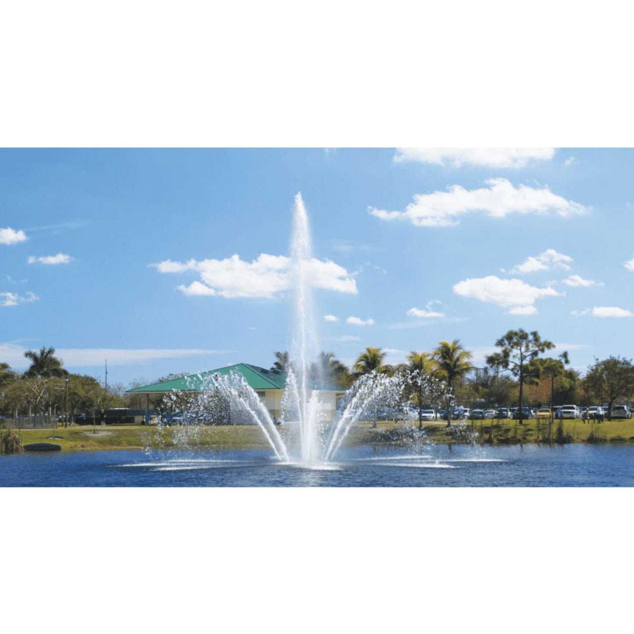 Vertex AerationJet Floating Pond Fountain With Many Cars And A Green Roof House Behind