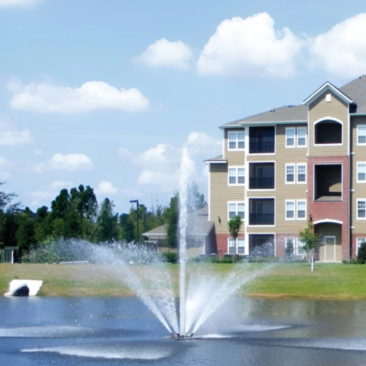 Vertex FanJet Floating Pond Fountain With Colorful Huge Building Behind