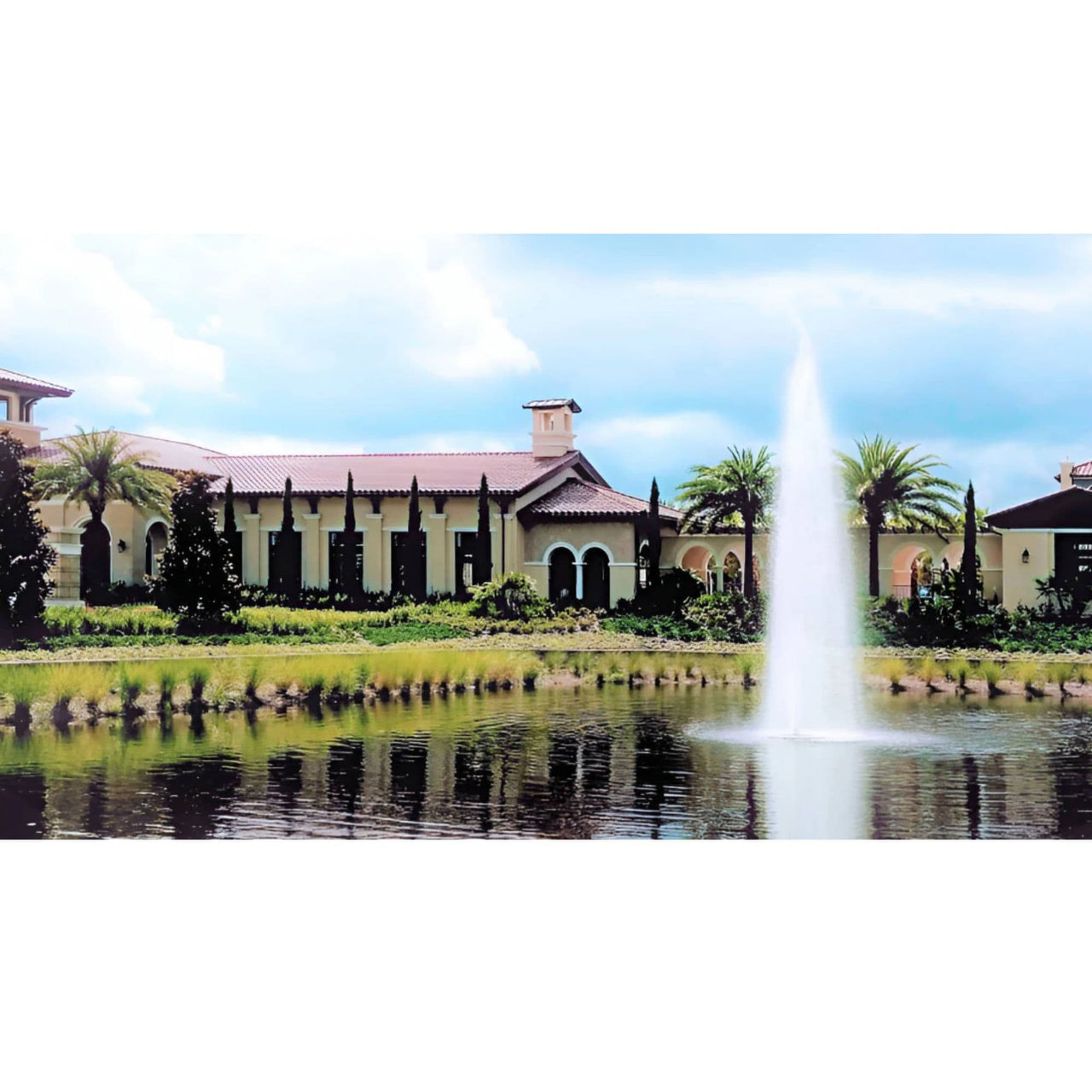 Vertex GeyserJet Floating Pond Fountain Stands Before Grand House