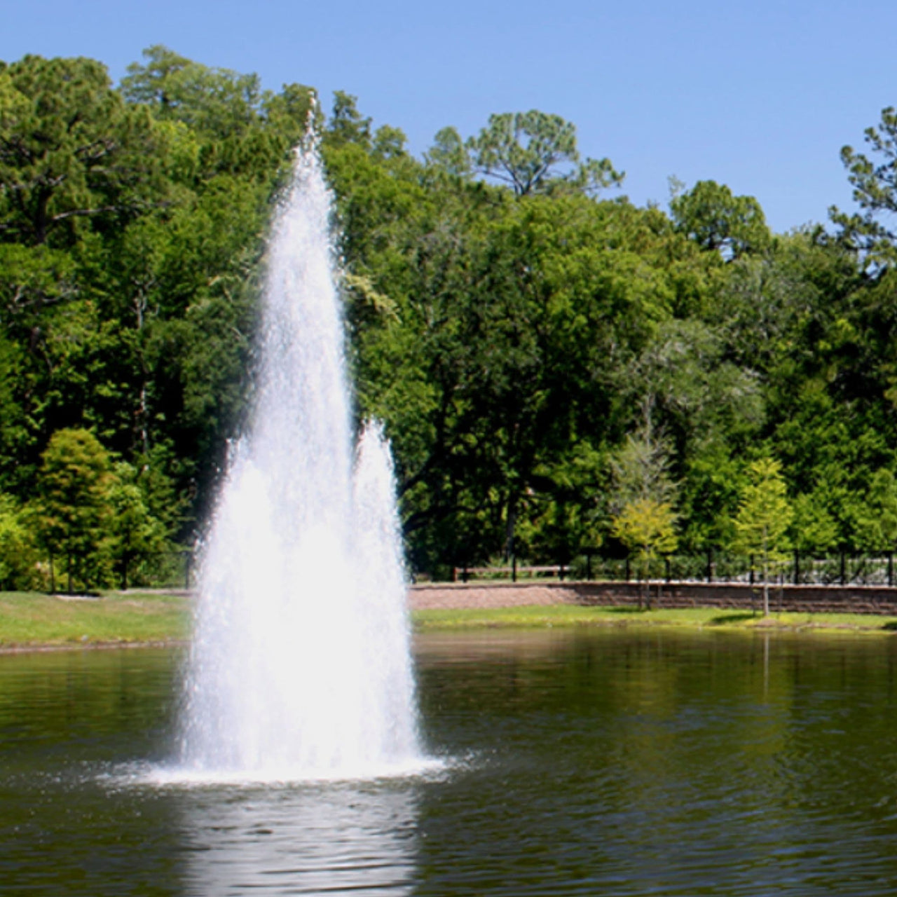 Vertex MultiGeyser Floating Pond Fountain Spraying Water With Green Trees Background