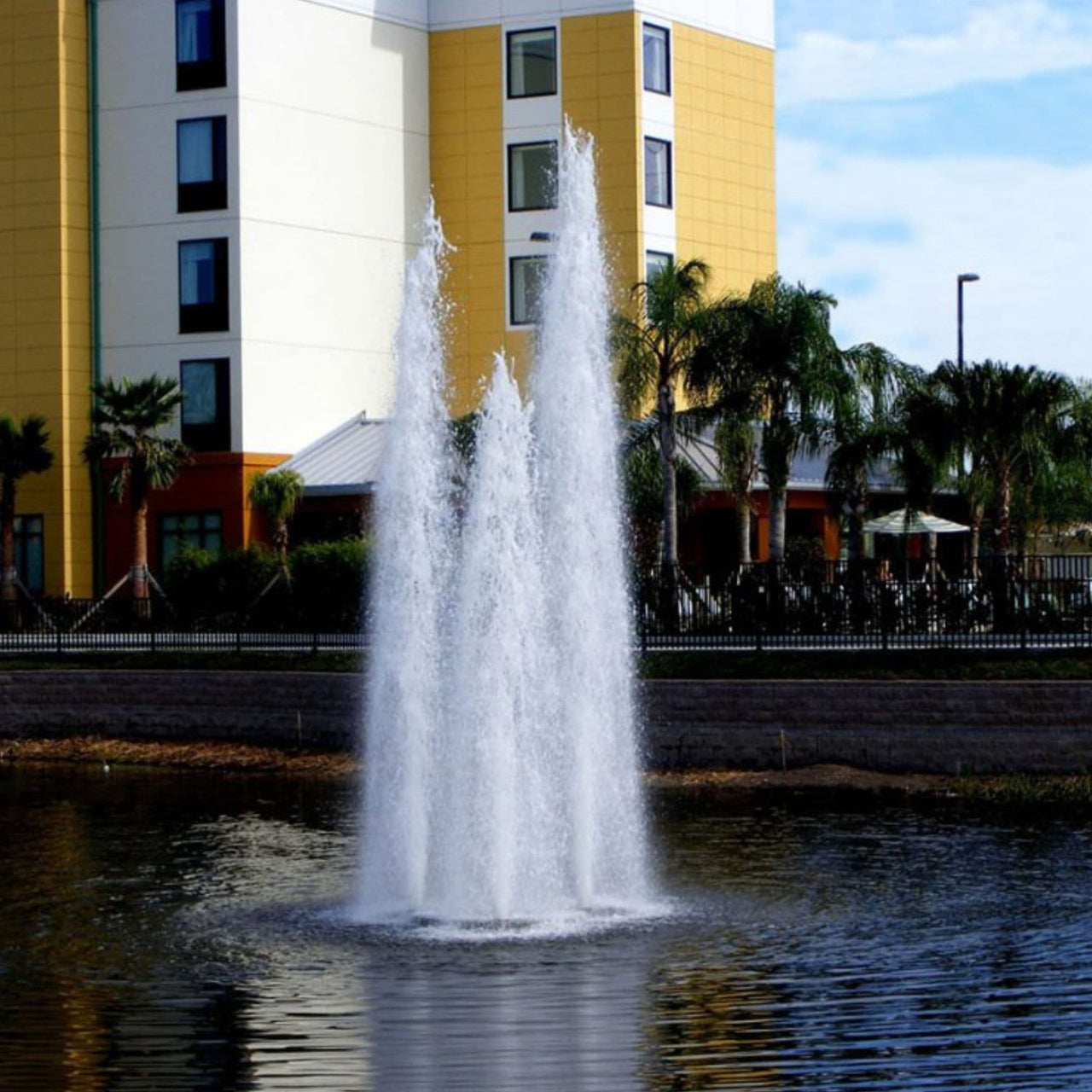 Vertex TriGeyser Floating Pond Fountain Majestic Water Water Flowing In Front Of Big Building