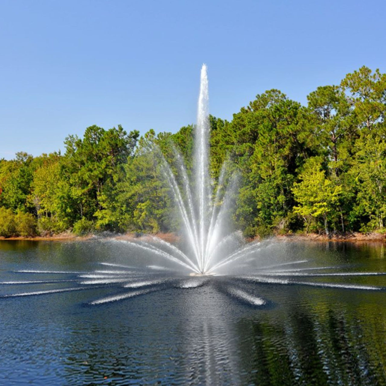 Vertex TriTier Floating Pond Fountain On Calm Water With Trees In The Background