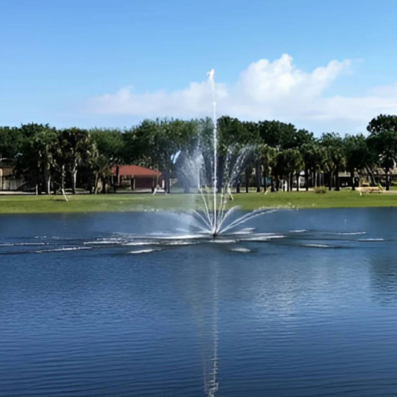 Vertex TriTier Floating Pond Fountain Water Splashing With House And Landscape Behind