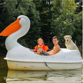 White Adventure Glass Pelican Classic 2 person paddle boat on a lake with two children and a dog aboard