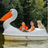 White Adventure Glass Pelican Classic 2 person paddle boat on a lake with two children and a dog aboard