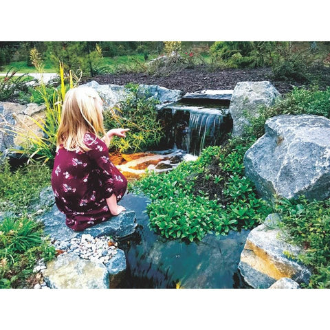 Girl beside a Blue Thumb Elite Spillway pondless waterfall