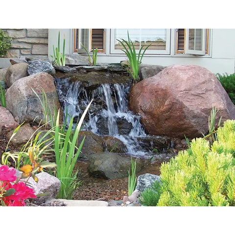 EasyPro pondless waterfall in a front yard with rocks and plants